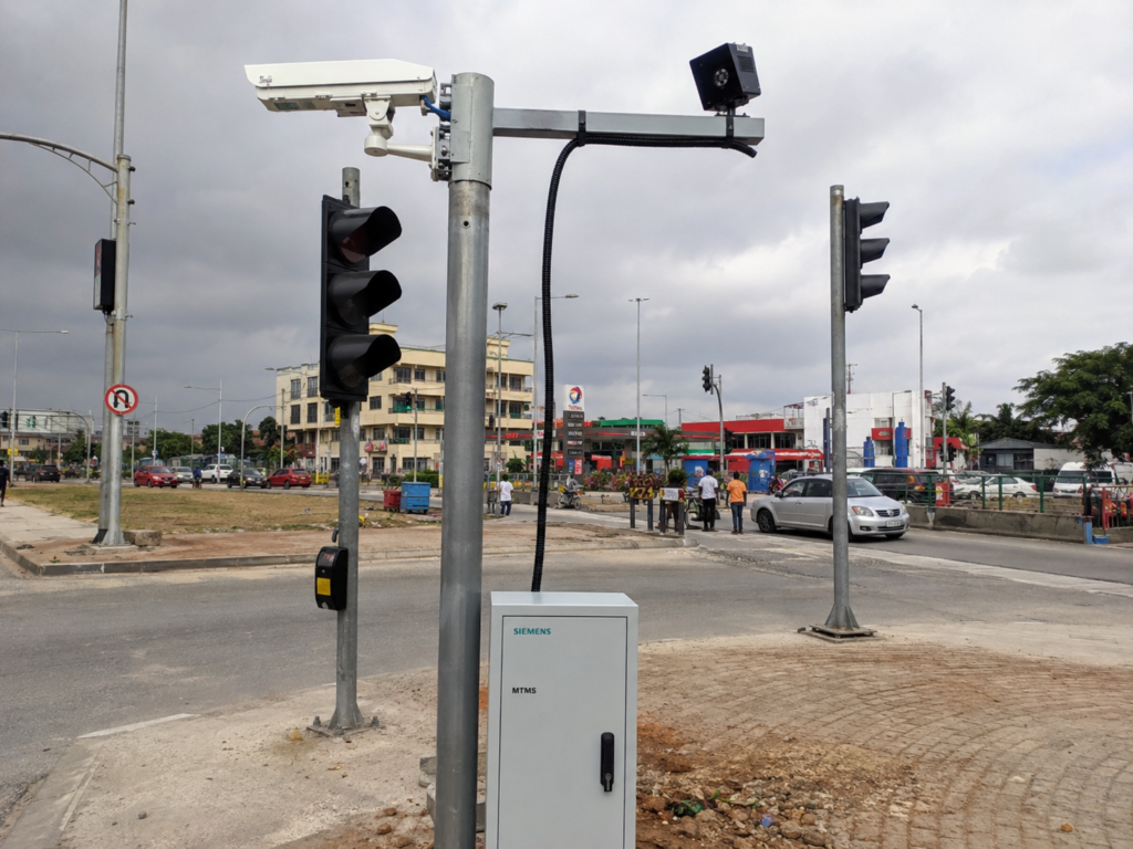 Smart city traffic sensor installed on signal pole at intersection