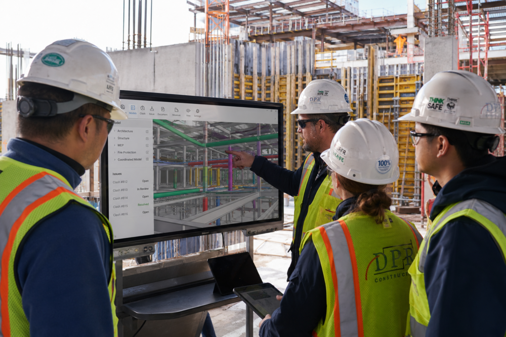 Engineering team reviewing BIM best practices coordination model on site